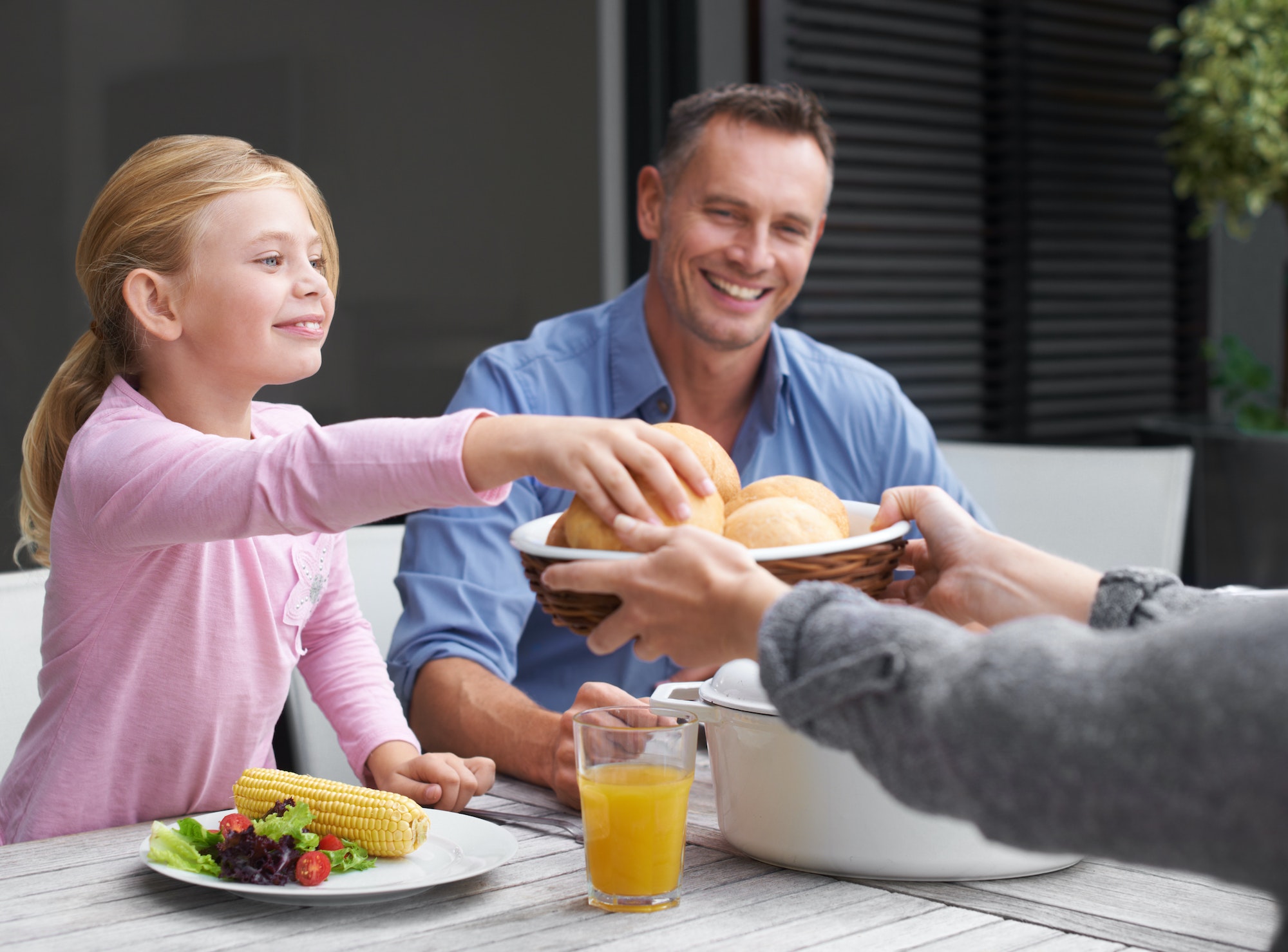 Enjoying lunch as a family. A family enjoying lunch together outside.